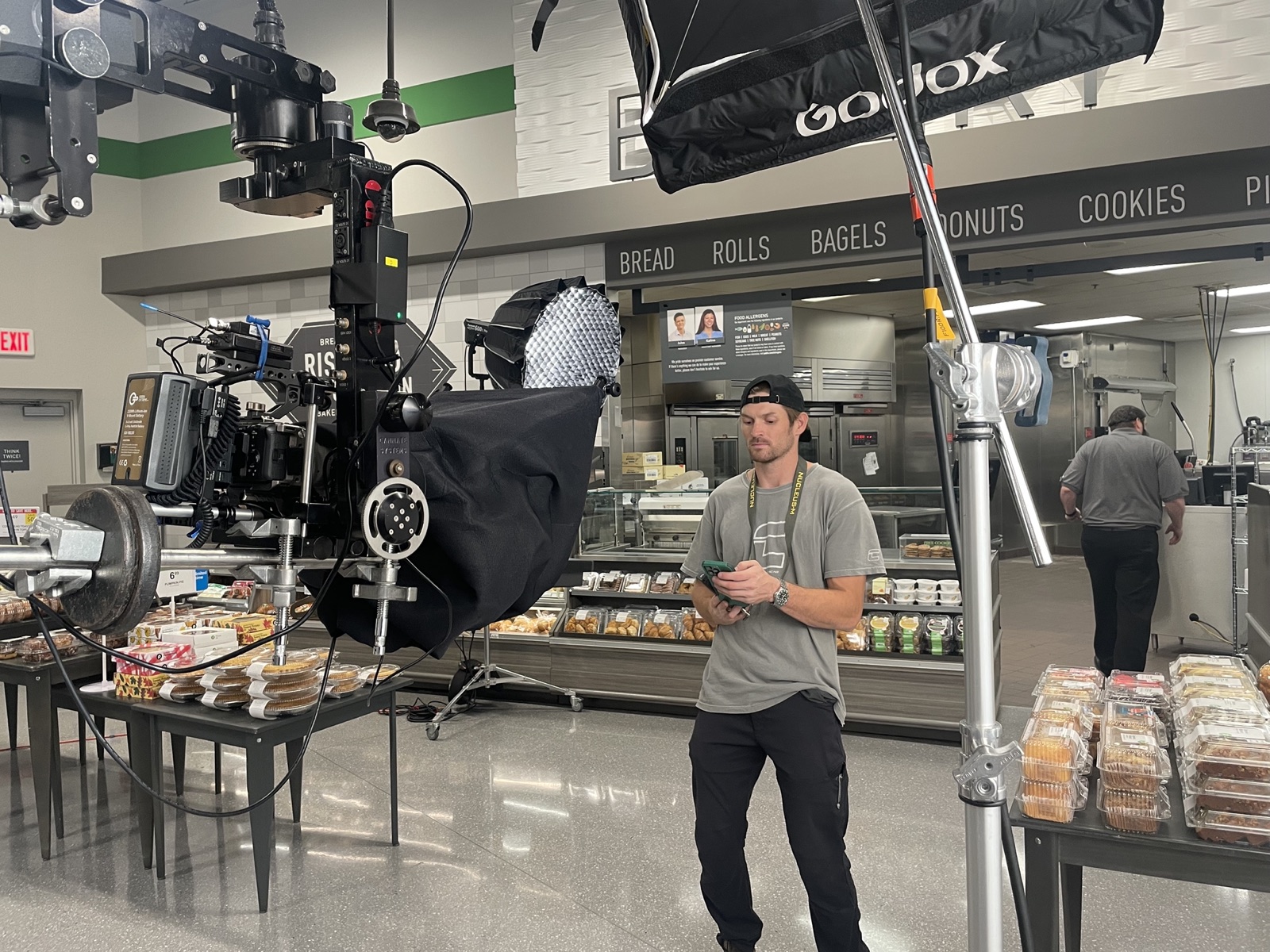 Camera crane and softbox lighting rig on a retail production set